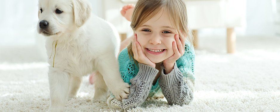 Little girl and puppy at home