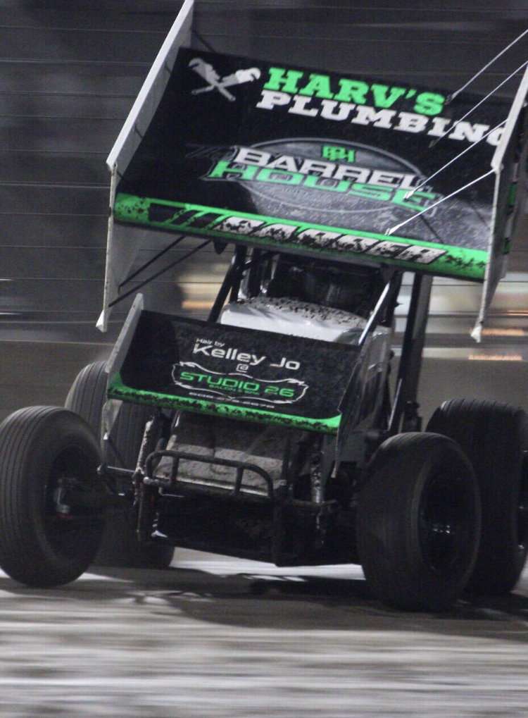 A race car is sponsored by harv's plumbing