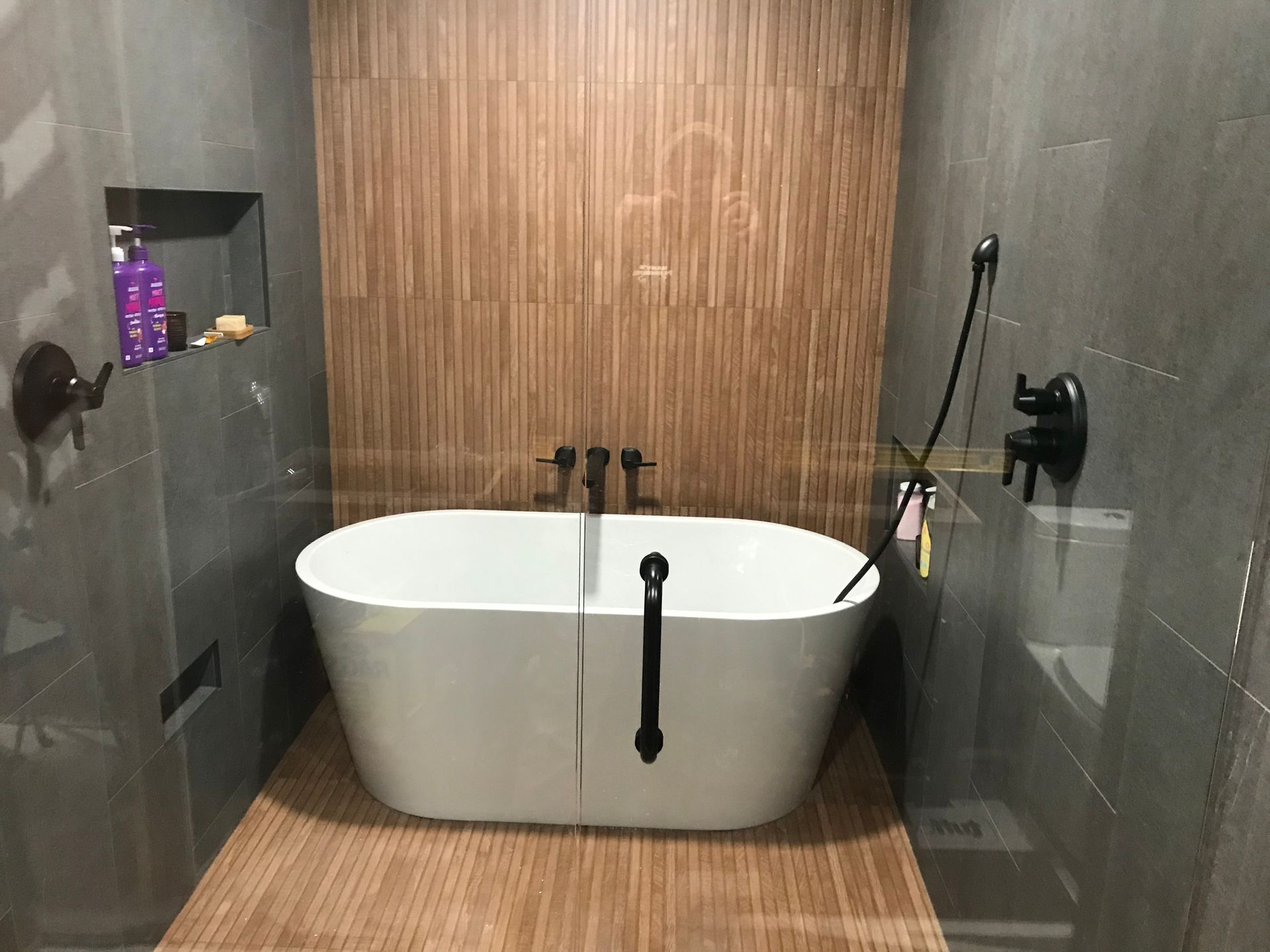 A bathroom with a bathtub and a shower.
