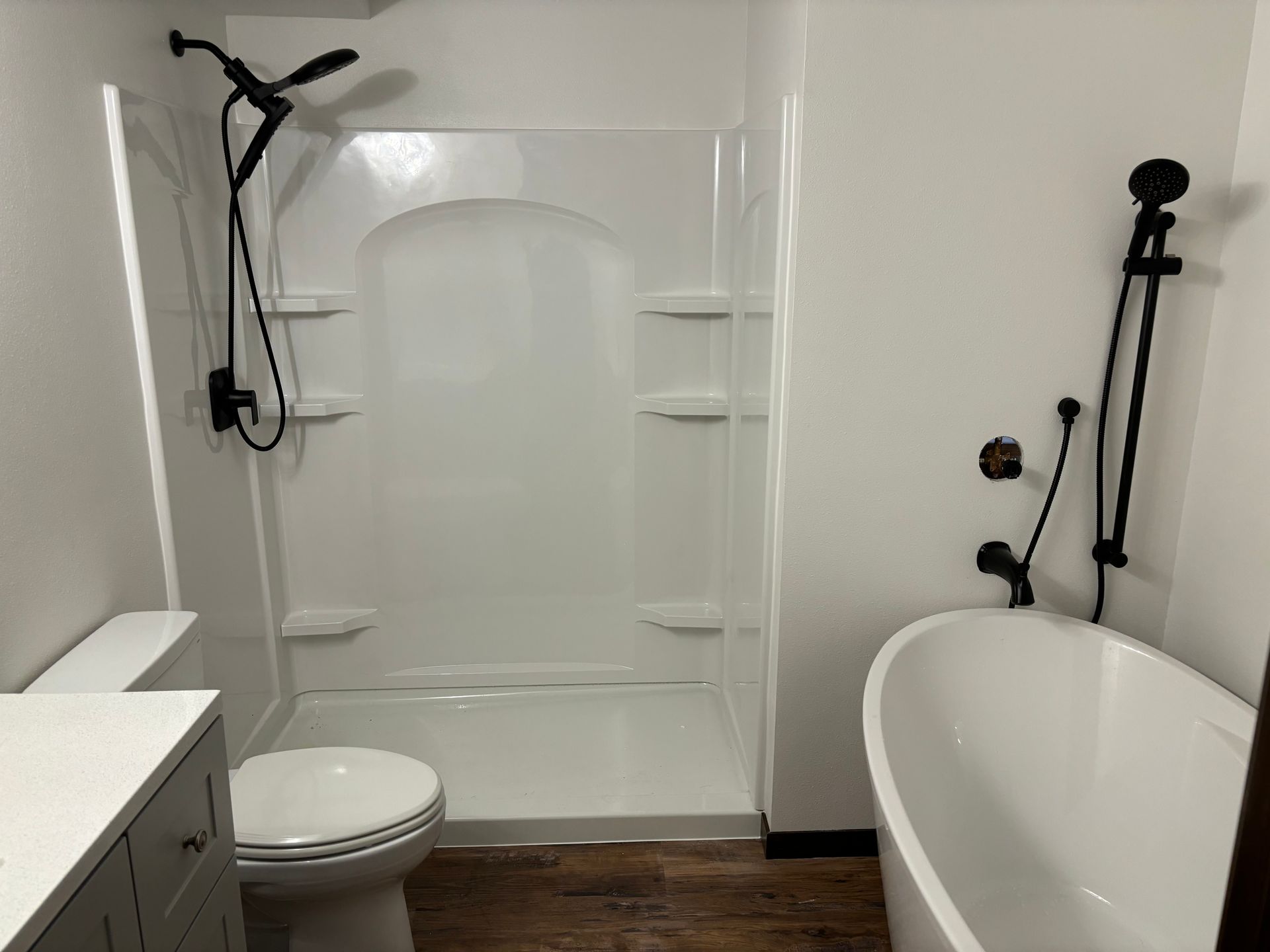 A bathroom with a toilet, shower and bathtub.