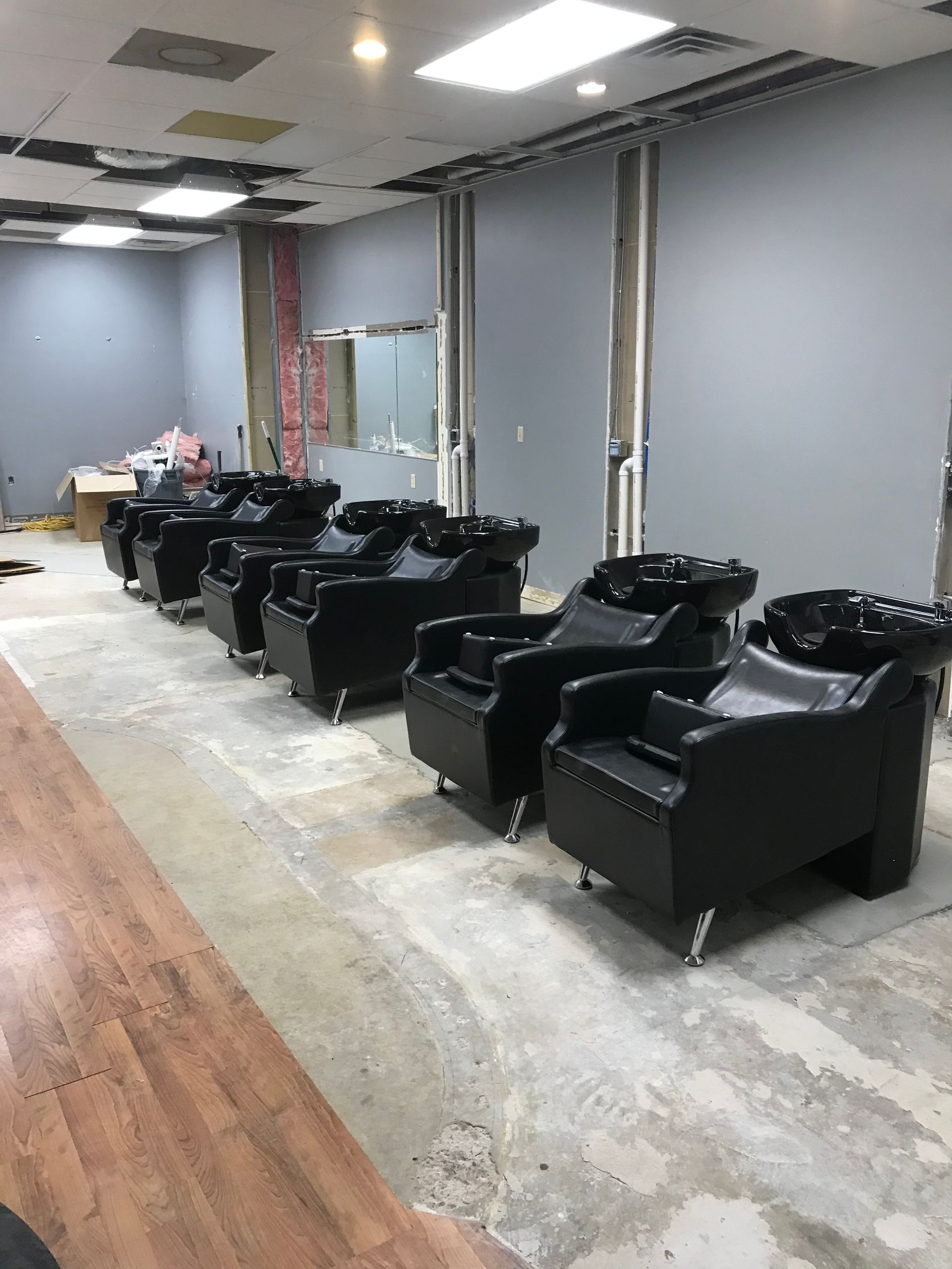 A row of black chairs are lined up in a room.