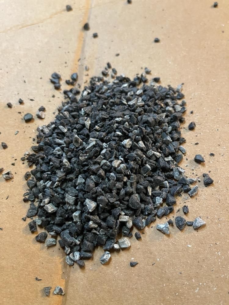 A pile of black rocks is sitting on a table.