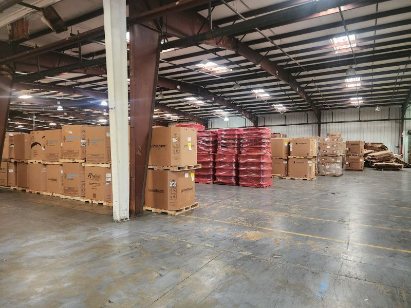 A large warehouse filled with lots of boxes and pallets.