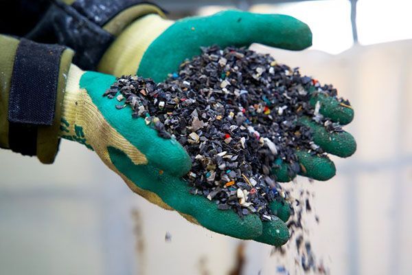 A white truck is parked in front of a building that says RSRH.