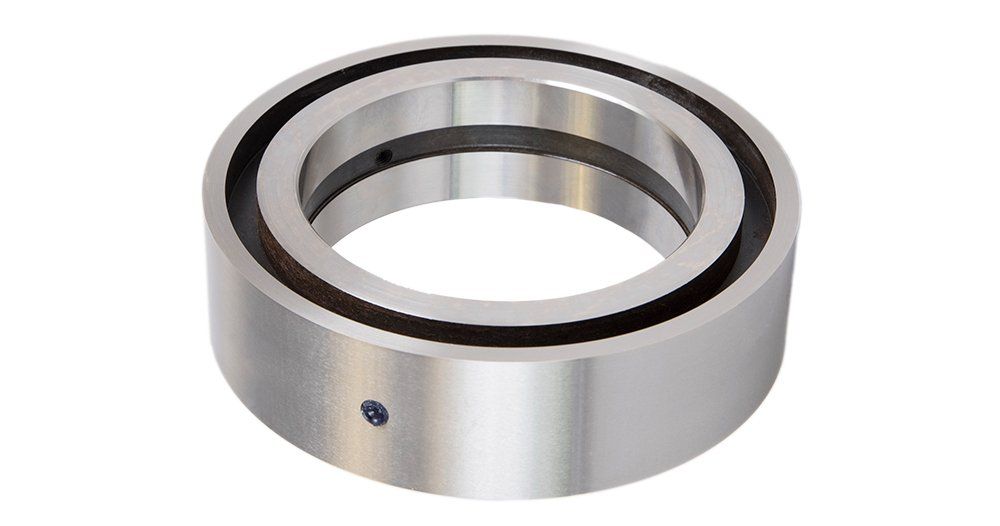 A metal ring with a hole in the middle on a white background.