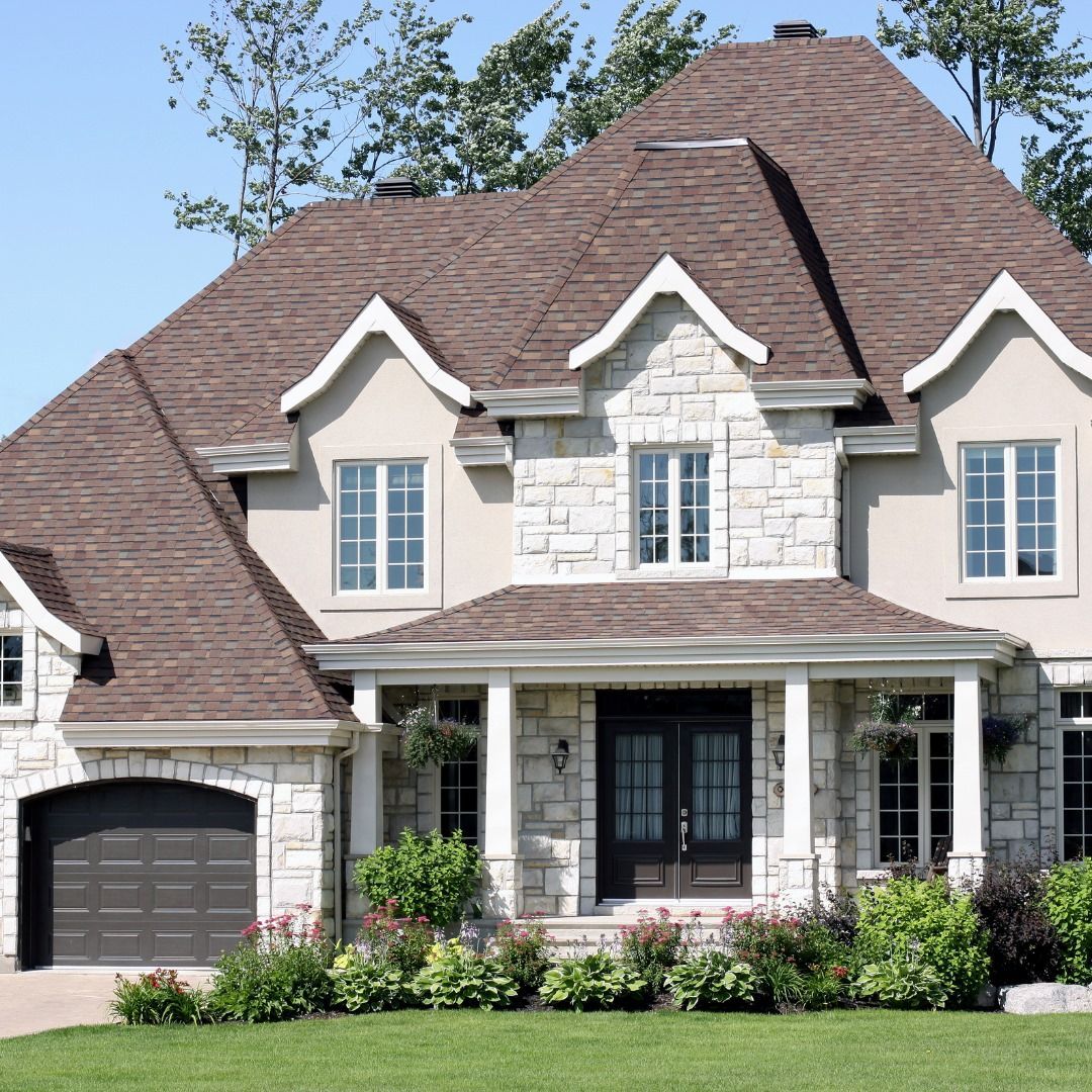 A large house with a brown roof and white trim