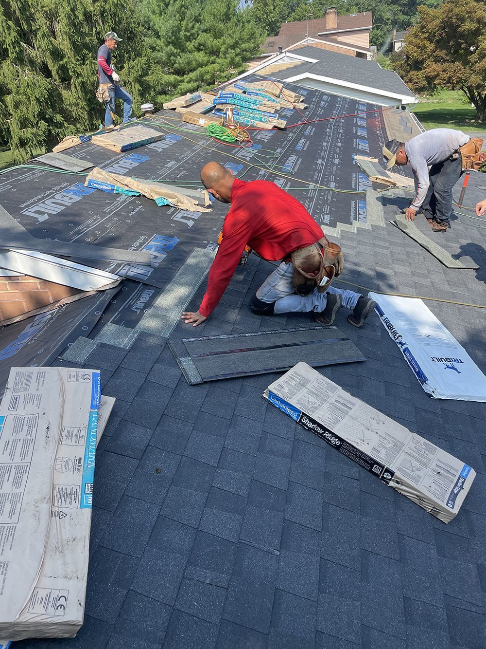 A group of people are working on a roof.