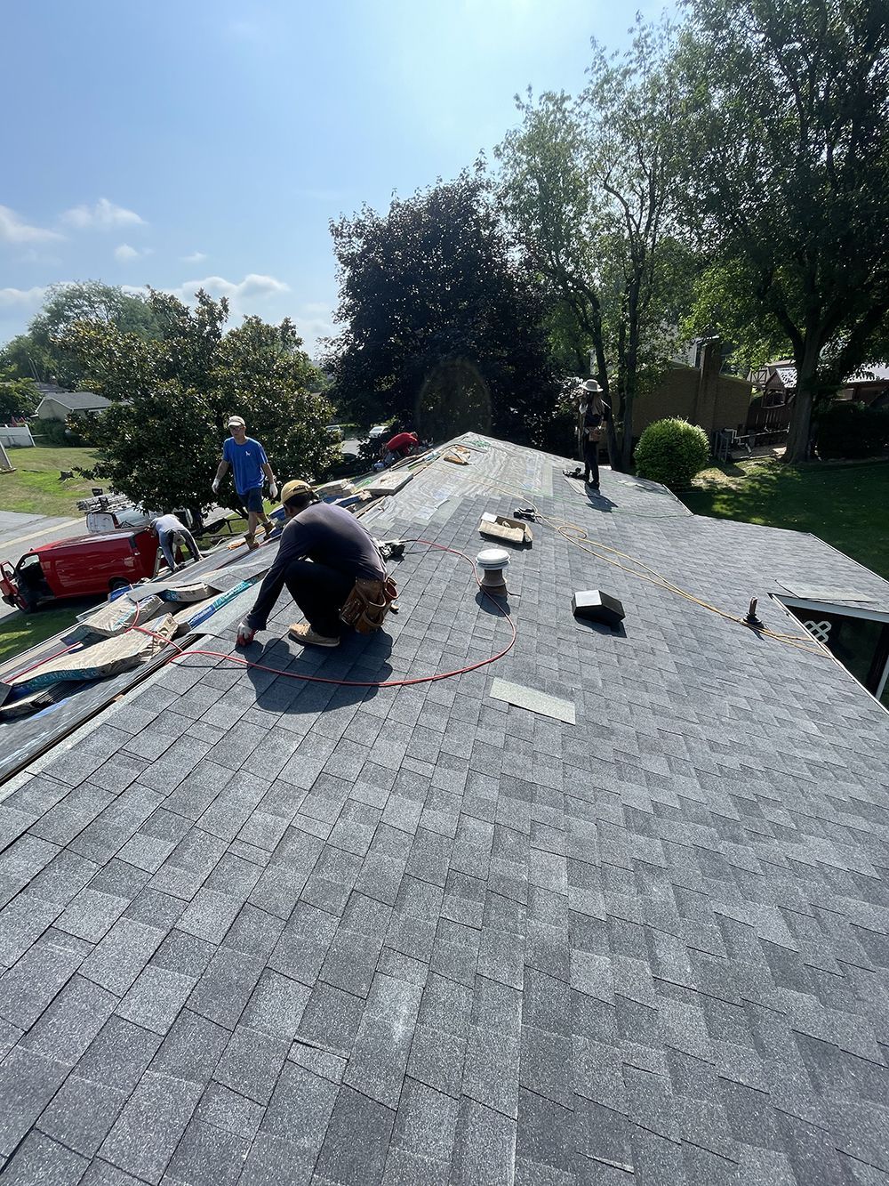 A man is working on the roof of a house.