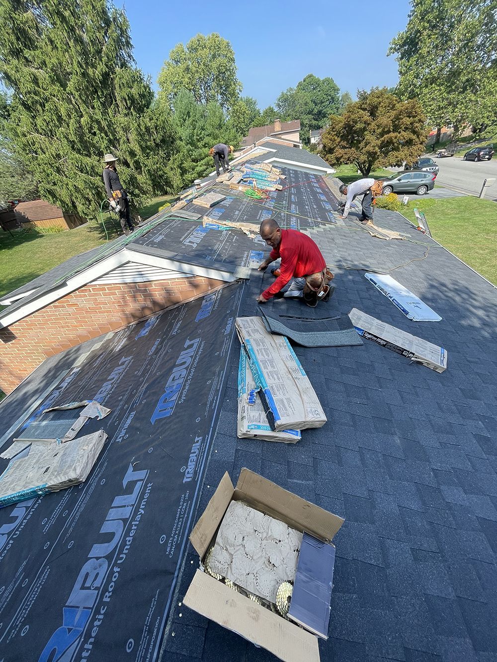 A man is working on the roof of a house.