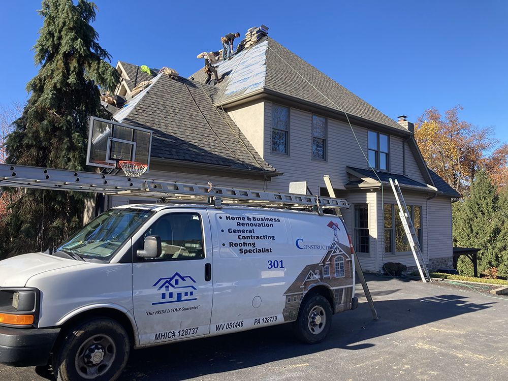 A white van is parked in front of a house.