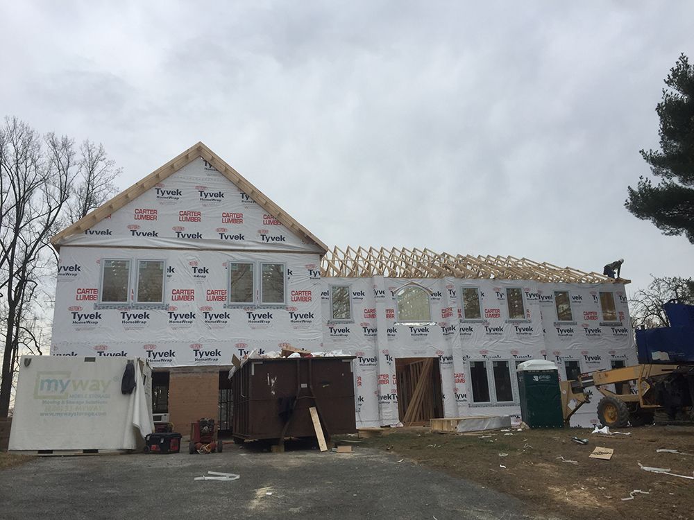 A large house is being built with a roof that is covered in styrofoam