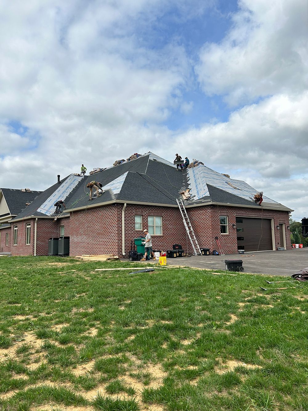 A house is being remodeled with a roof being installed.