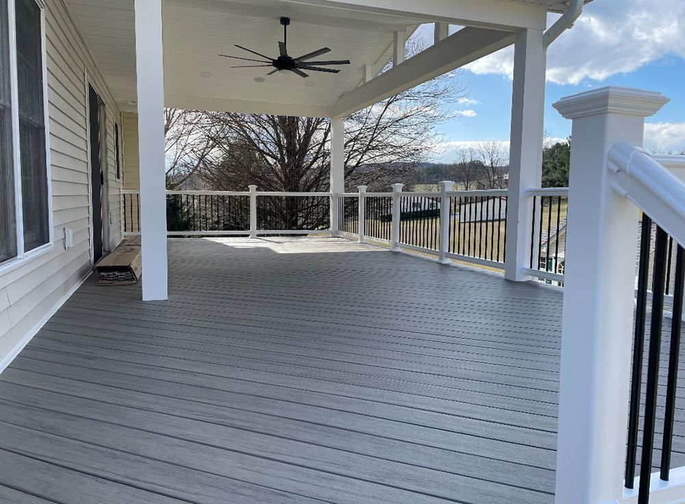 There is a ceiling fan on the porch of a house.