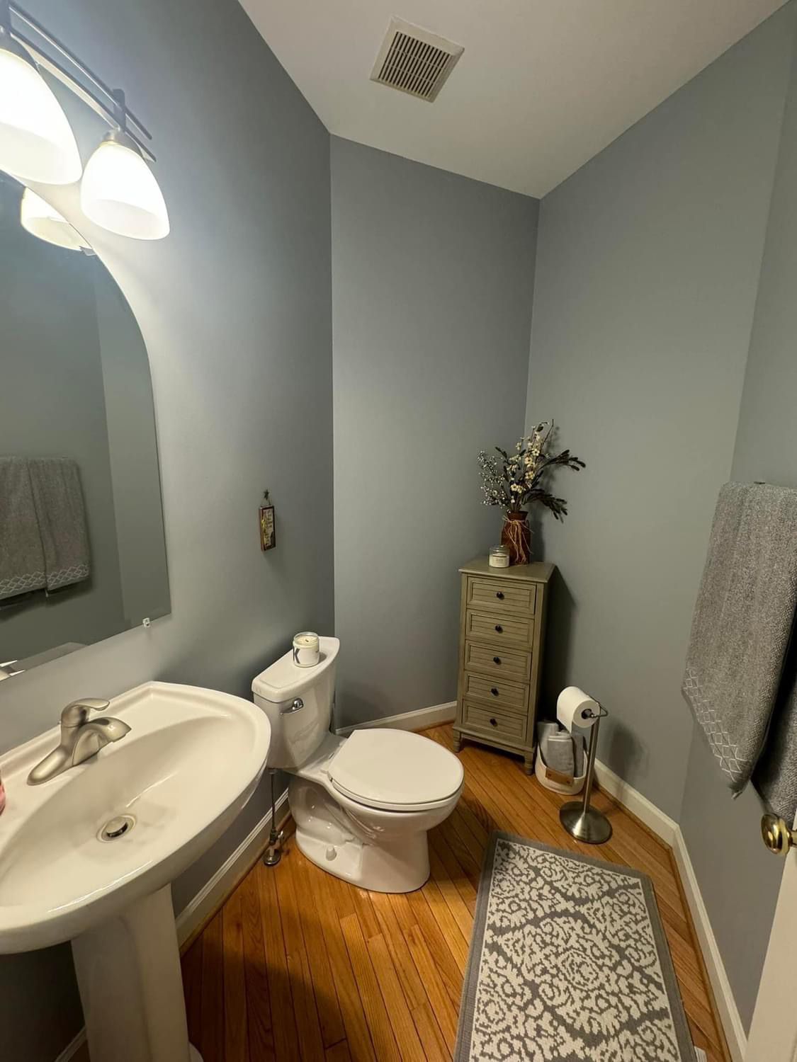 A bathroom with a sink , toilet , and mirror.