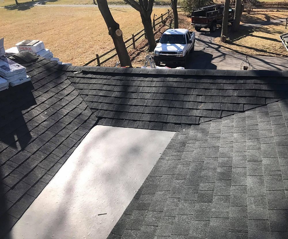 A white truck is parked on the roof of a house.