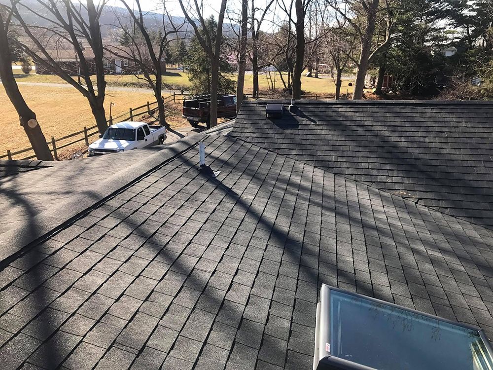 A car is parked on the roof of a house.
