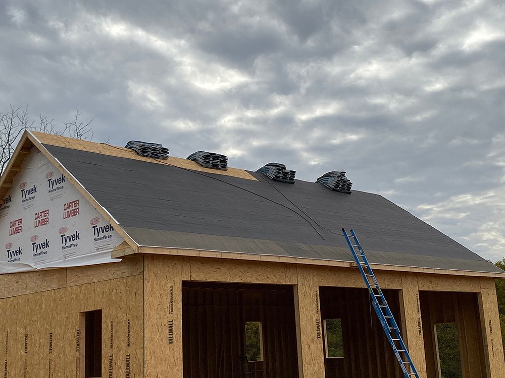 A house is being built and the roof is being installed.