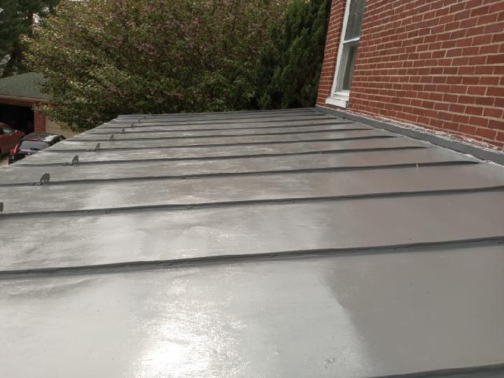 A metal roof is sitting on top of a brick building.