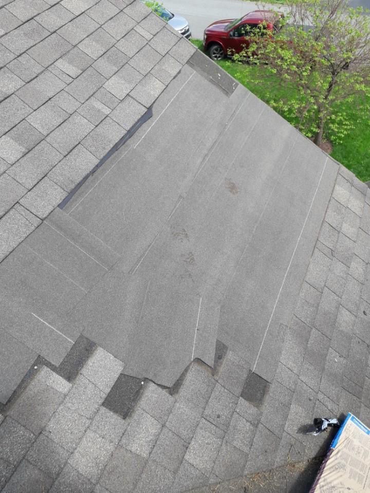 An aerial view of a roof with a red truck parked in the background.