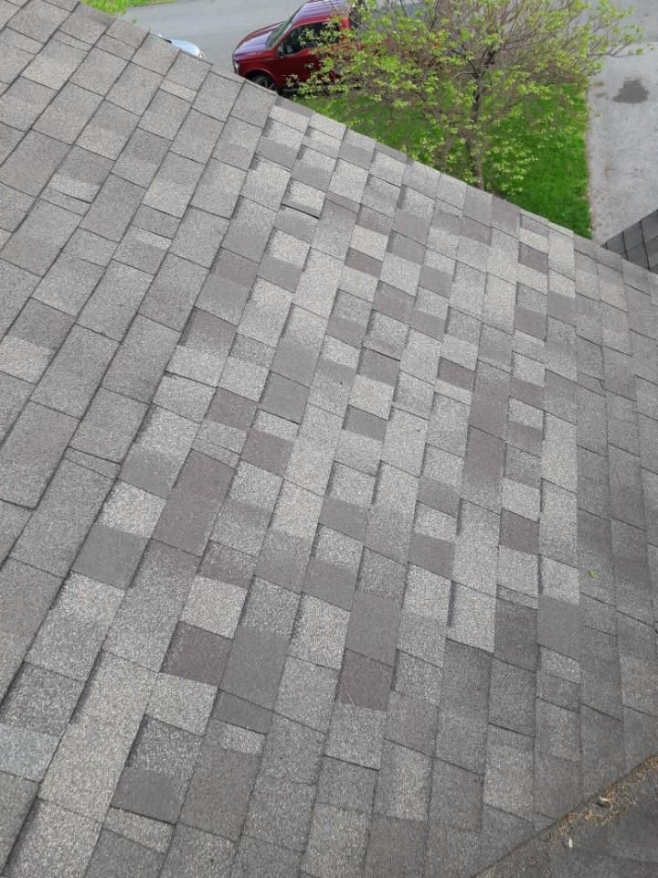 A close up of a roof with a car parked on the side of it.