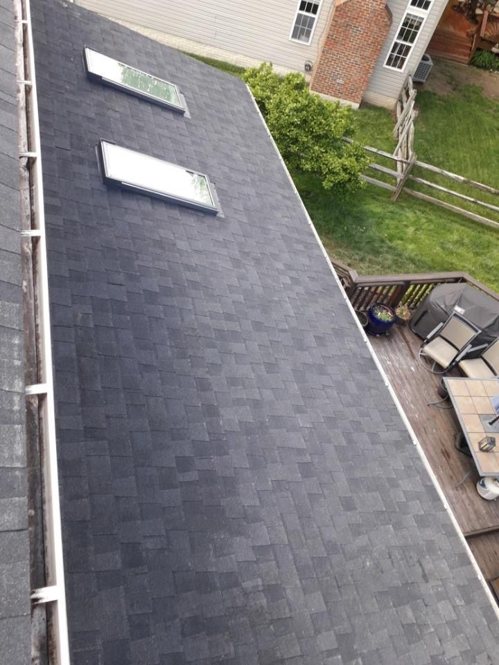 There are three skylights on the roof of a house.