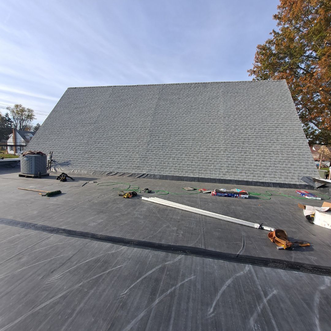 A large roof is being installed on a house.