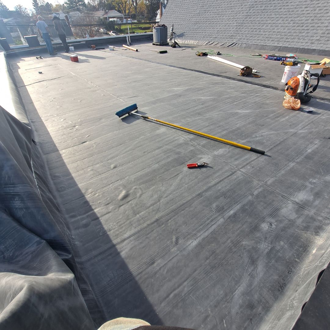 A person is standing on a roof with tools on it.