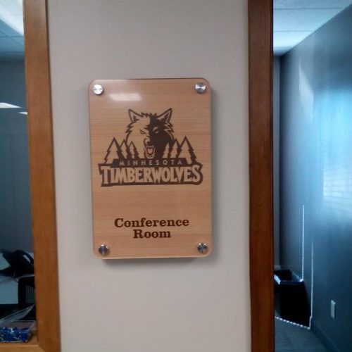Wooden conference room sign with Minnesota Timberwolves logo.