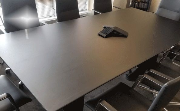 Black conference table with chairs in a meeting room.