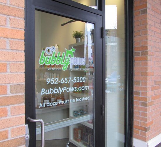 Black framed glass door entrance to 