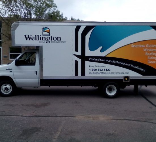 White Wellington Home Improvements truck parked on asphalt.