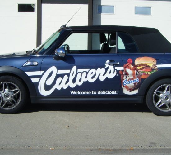 Blue Culver's branded convertible car with logo and food images.