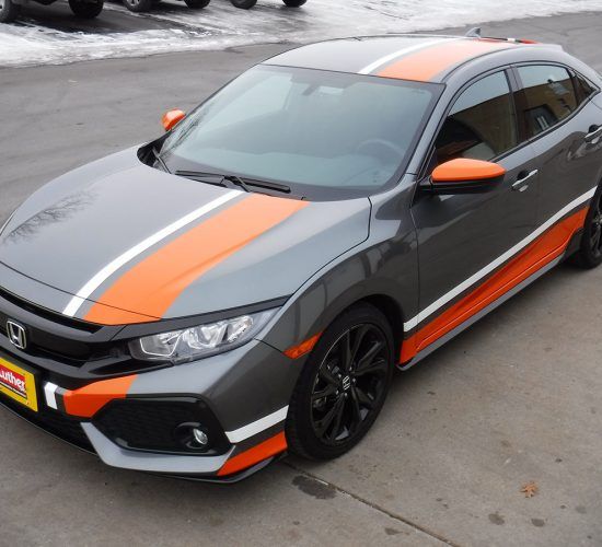 Gray Honda Civic with orange and white racing stripes, black wheels, and orange accents.
