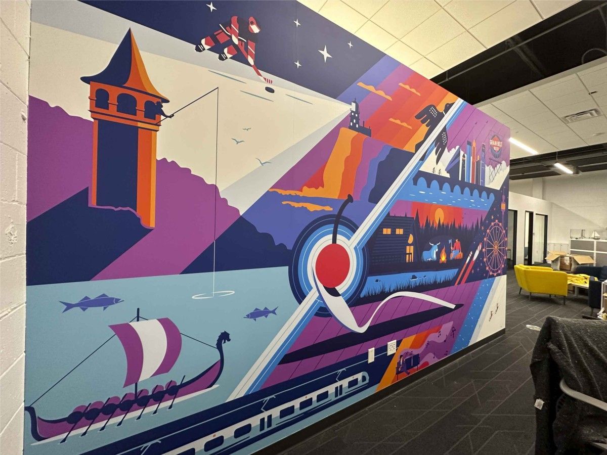 Colorful mural on a wall featuring a Viking ship, a train, and an airplane against a mountainous backdrop.