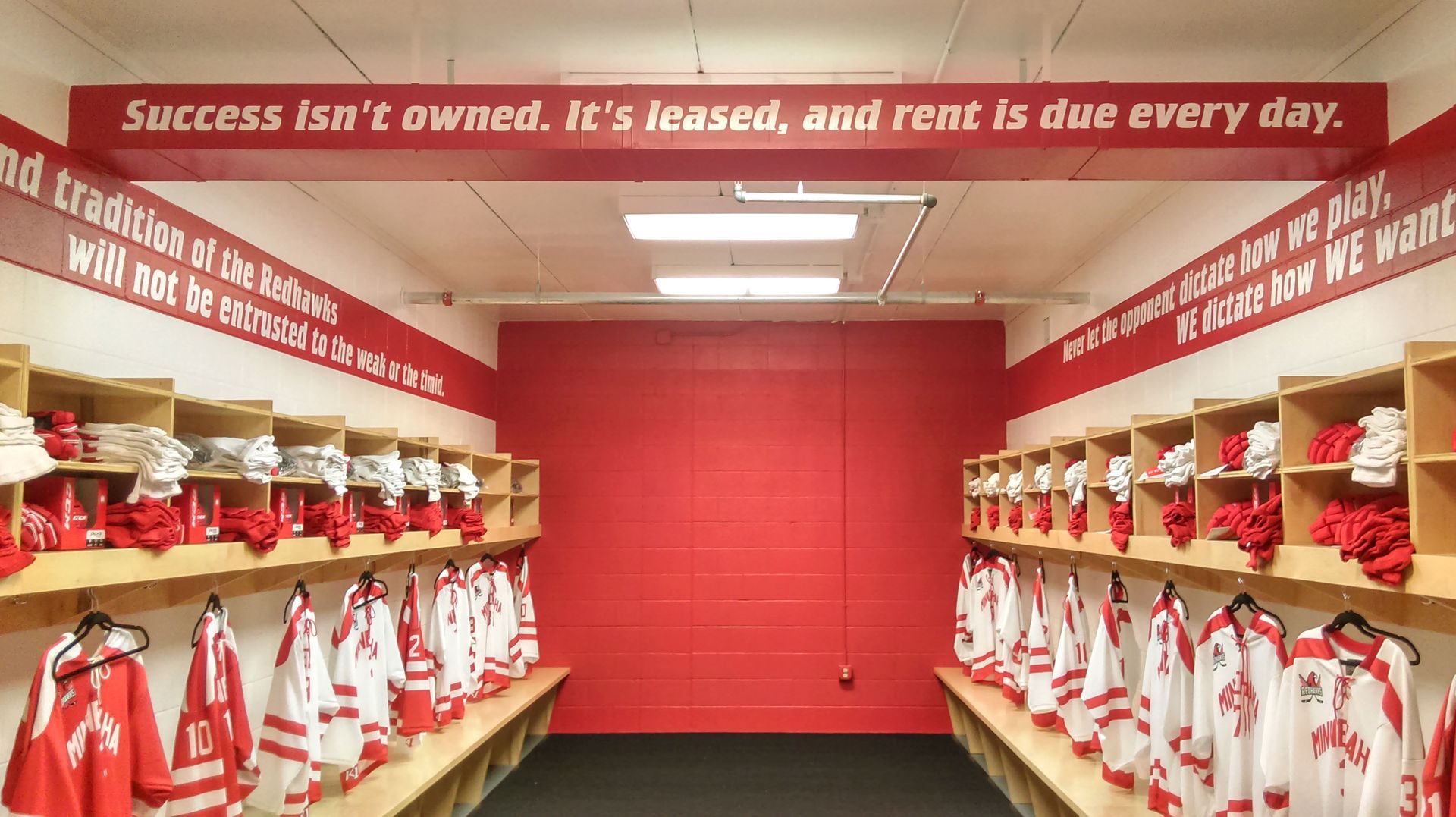 Hockey team locker room with red and white uniforms. Inspirational quote: 