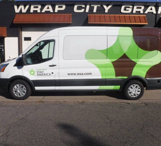 White van with green and brown abstract design, 