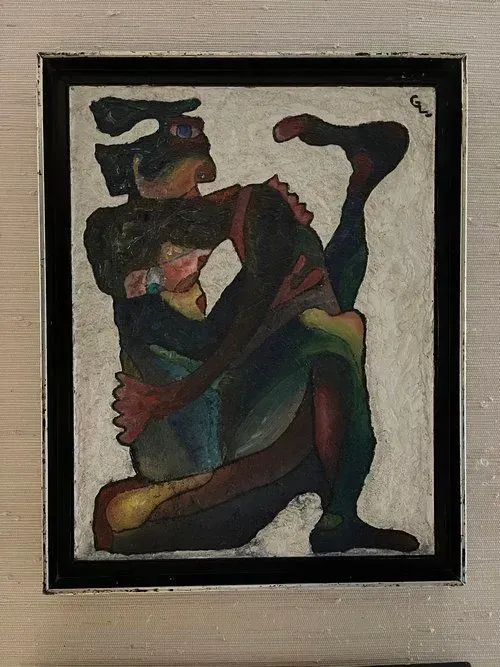 Abstract painting of two figures intertwined, in shades of blue, green, and red, on a white background, framed in black.