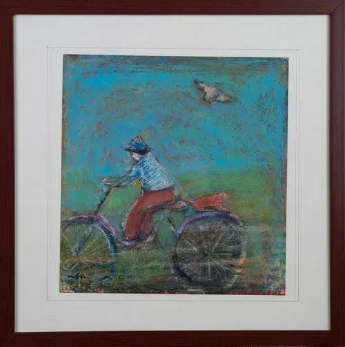 A person on a tricycle under a blue sky, with a bird flying above.