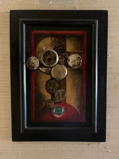 Mixed media artwork in a black frame, features circles, a green eye, and a red and gold background.