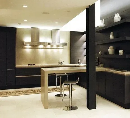 Modern kitchen with dark cabinetry, stainless steel appliances, and a counter with stools.