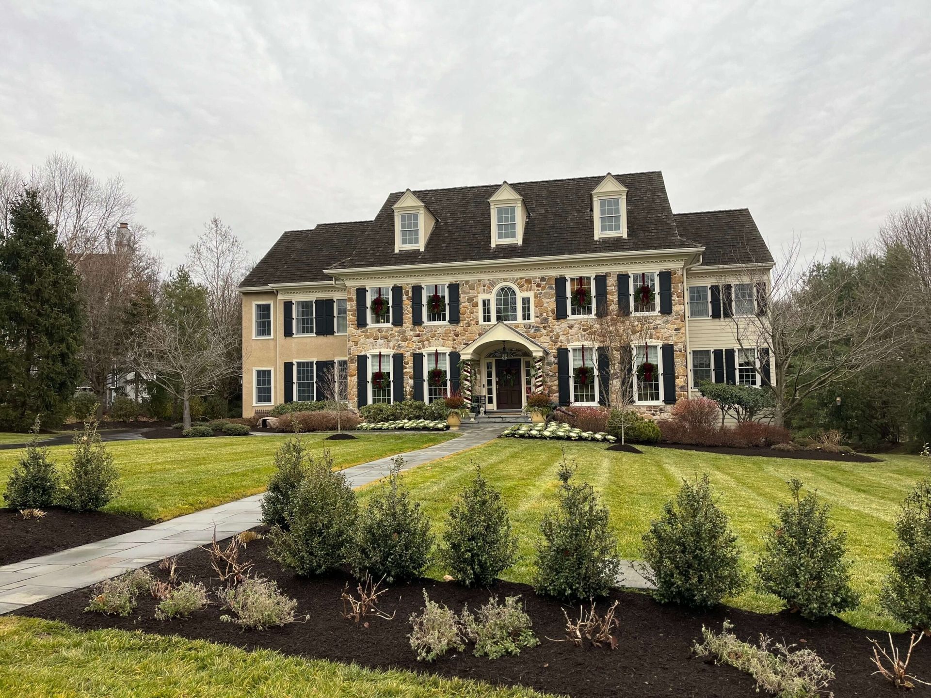 A large house with a lush green lawn in front of it.