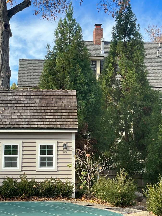 A house with a basketball court in front of it