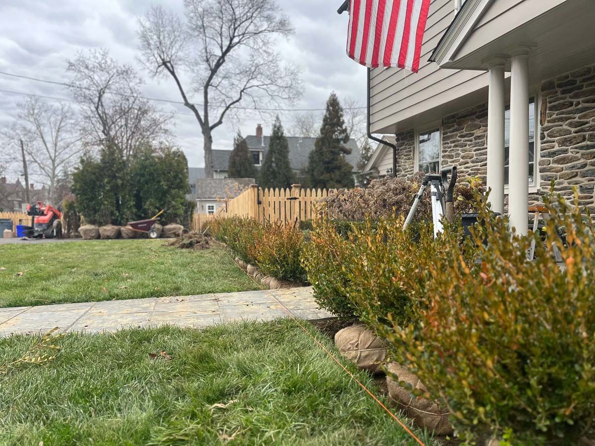 A house with a flag on the front of it and a lawn in front of it.