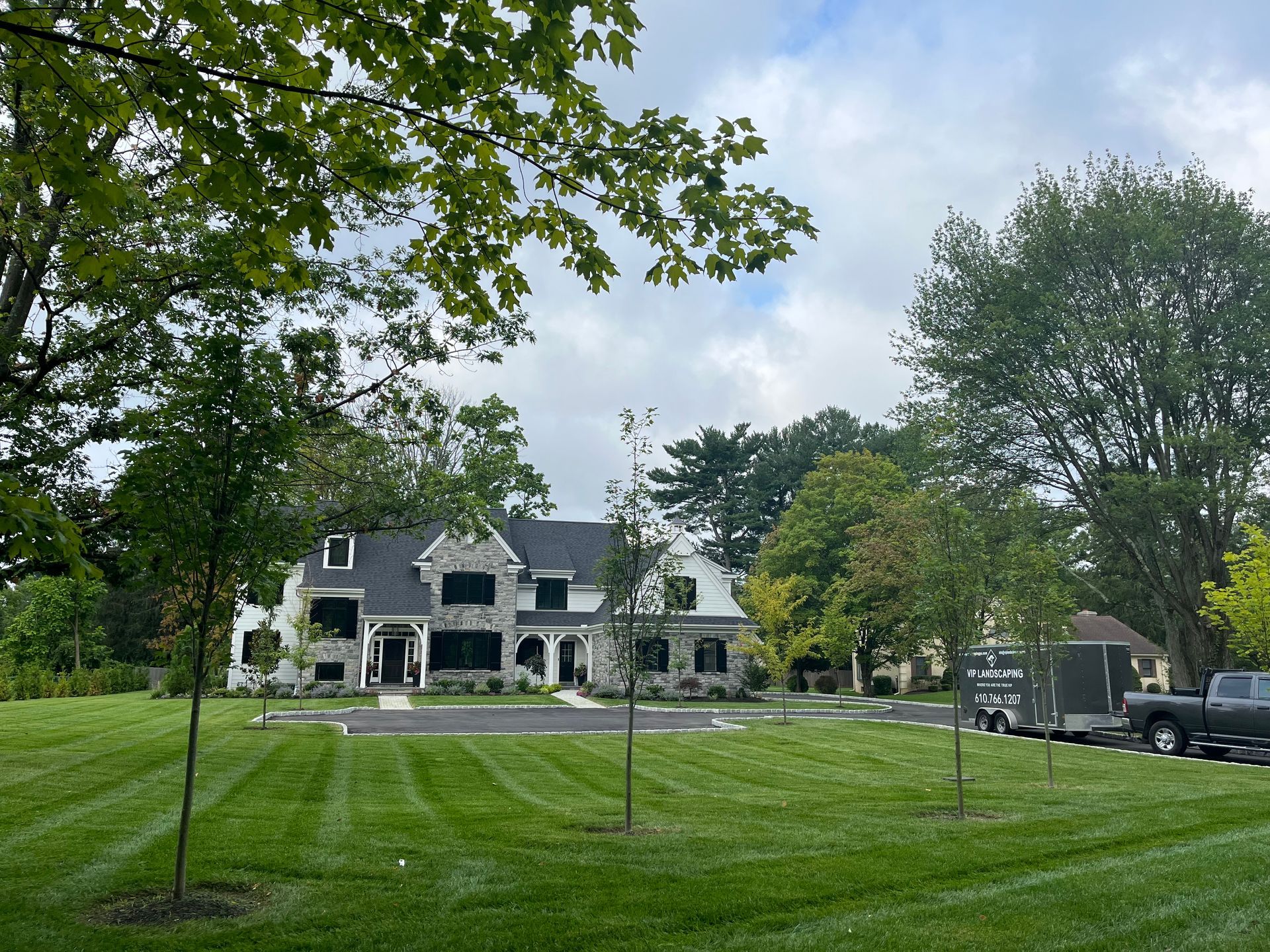 A large house with a lush green lawn in front of it.