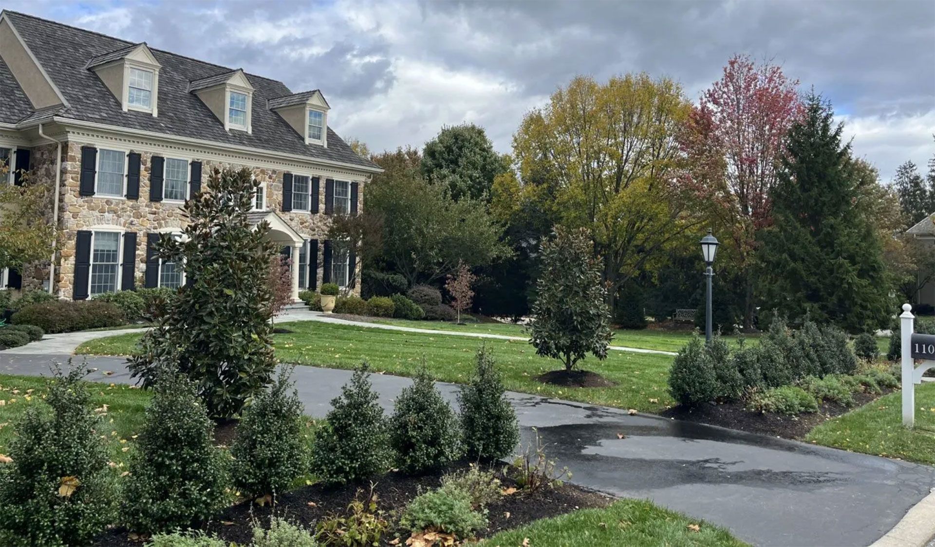 A large house with a lot of trees in front of it