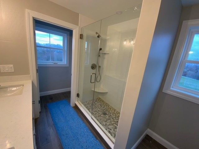 A balcony with a lot of windows and trees in the background.