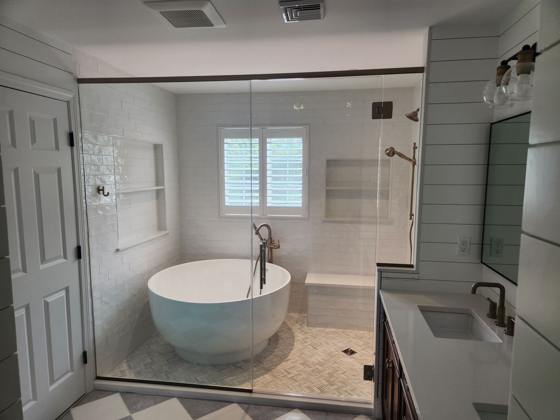 A bathroom with a bathtub , toilet and shower.