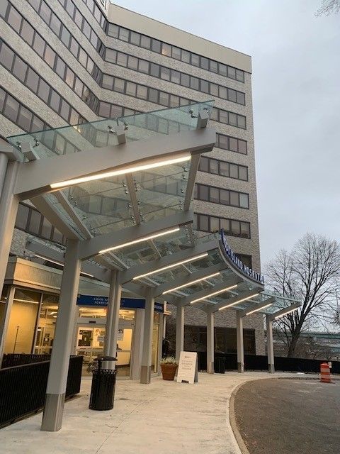 A large building with a glass canopy over the entrance