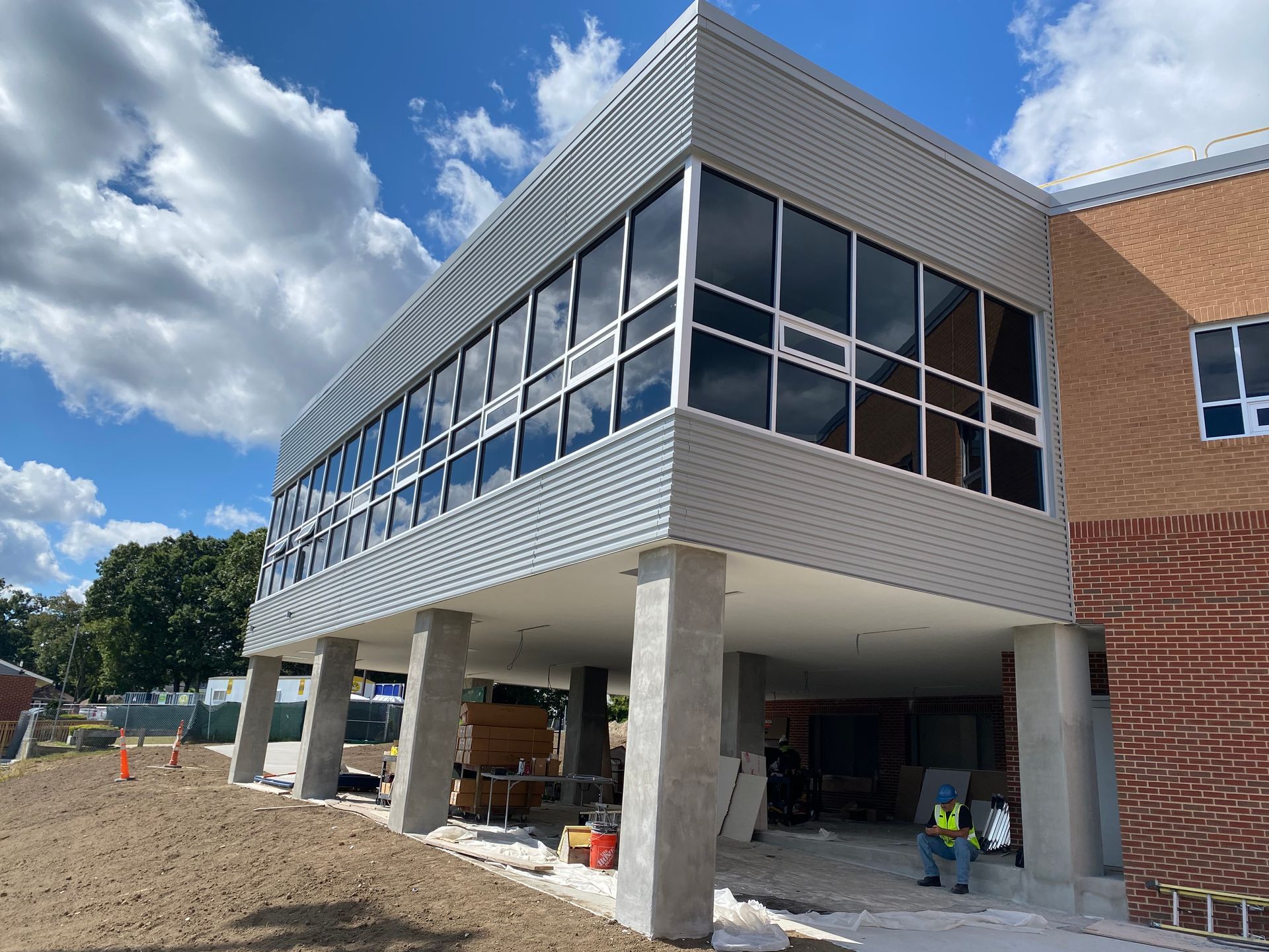 A large building with a lot of windows is under construction.