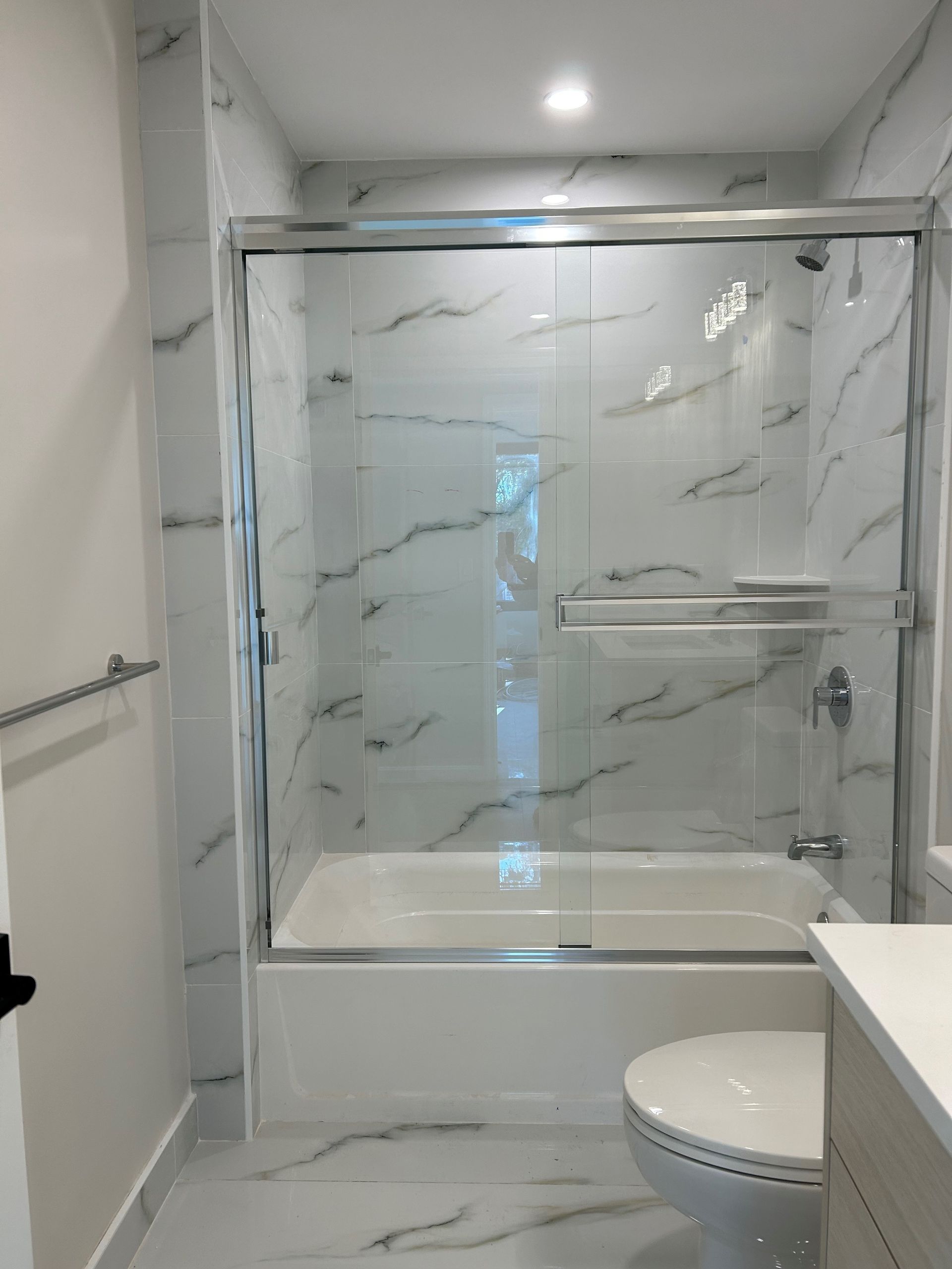 A bathroom with a tub , toilet and shower.